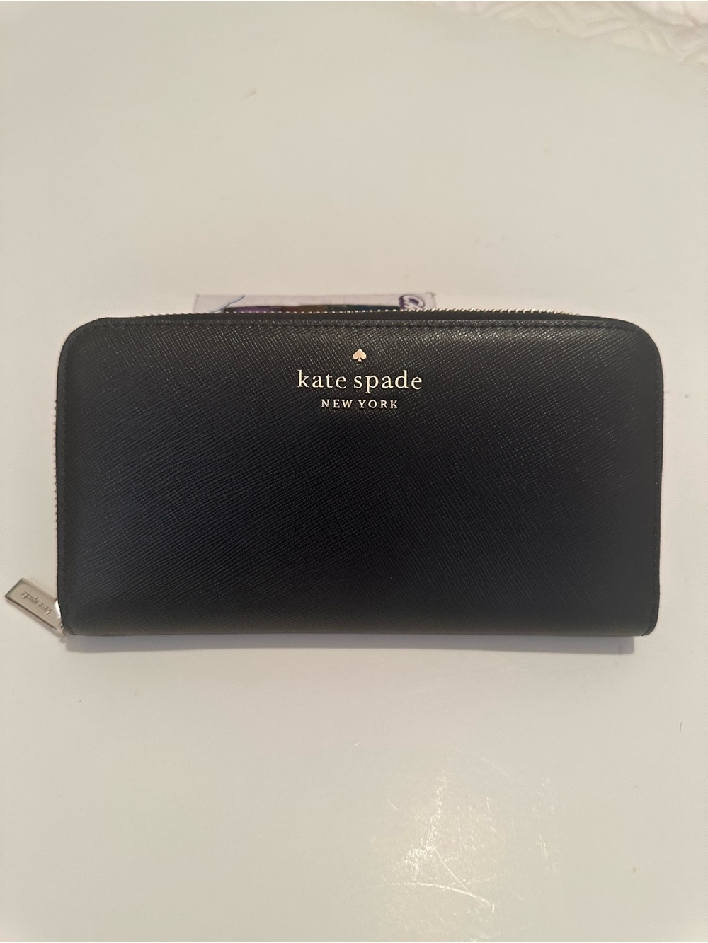kate spade black saffiano zip-around wallet with gold logo